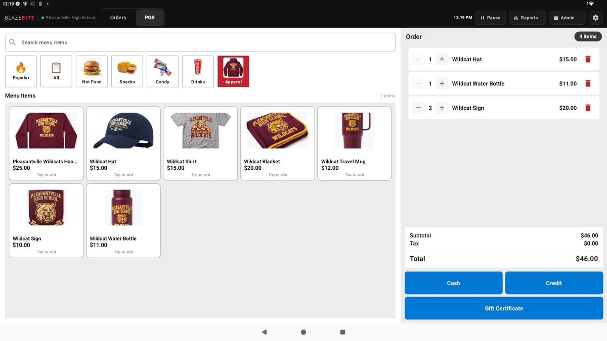 The BlazeBite terminal on the Apparel category, showing school hoodies, hats, shirts, blankets, mugs, water bottles, and signs with prices, and three of them in the order on the right