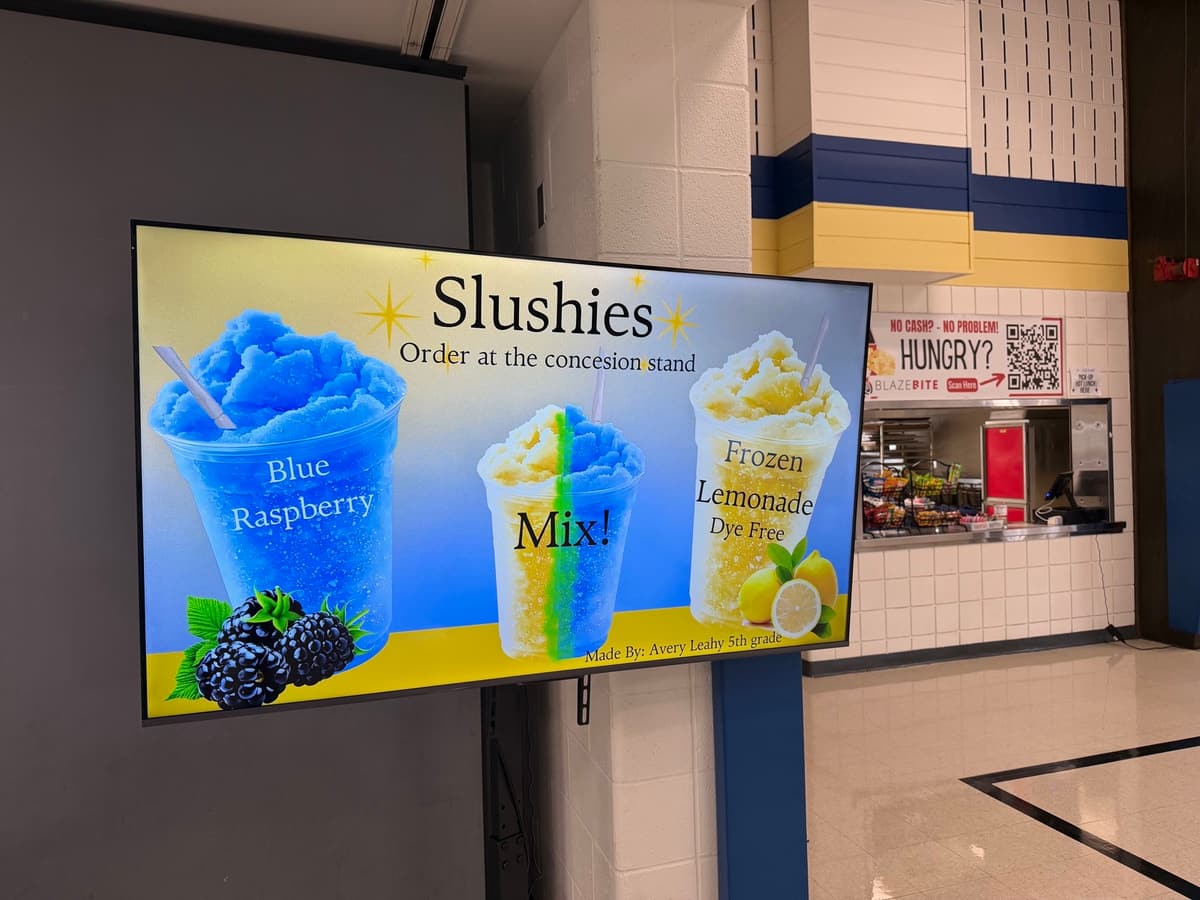 A sponsor ad for slushies filling the screen on a BlazeBite board at a school concession stand