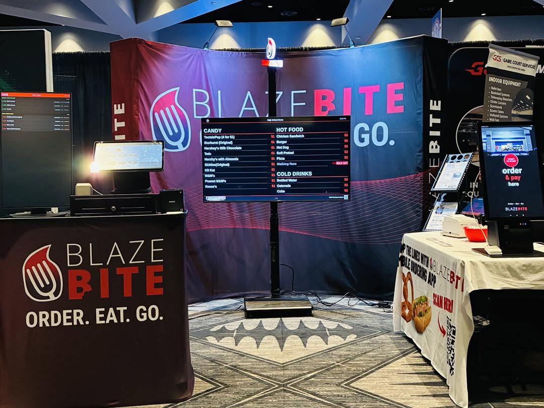 A BlazeBite digital menu display set up on a TV at an event venue