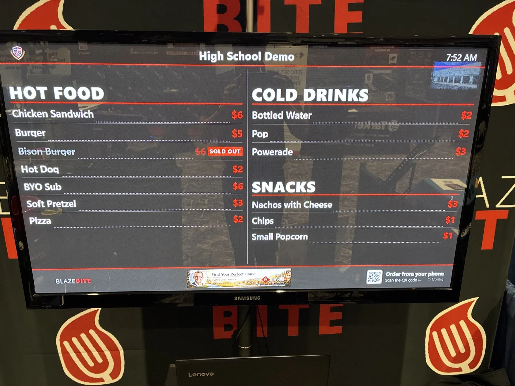 Close-up of a BlazeBite digital menu board displaying menu items and prices on a TV screen