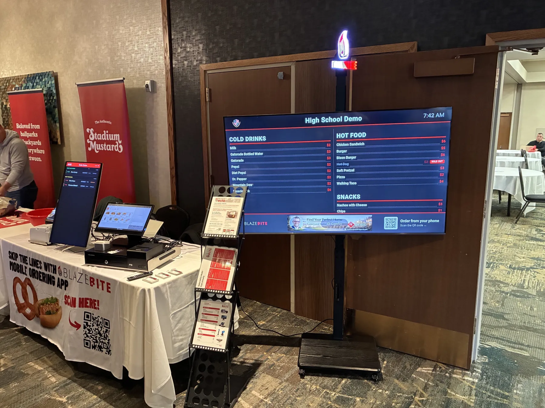Digital menu board with a sponsor ad banner along the bottom